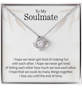 Lifestyle Gear, LLC's Love Knot Necklace - A symbol of unbreakable love featuring a beautiful pendant with cubic zirconia crystals. Available in 14k white gold or 18k yellow gold over stainless steel, with an adjustable chain and lobster clasp for a perfect fit.