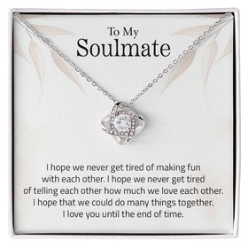 Lifestyle Gear, LLC's Love Knot Necklace - A symbol of unbreakable love featuring a beautiful pendant with cubic zirconia crystals. Available in 14k white gold or 18k yellow gold over stainless steel, with an adjustable chain and lobster clasp for a perfect fit.